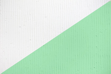 Closeup of the wall with a decorative plaster vertical lines and stripes. Trendy colored dual tone...