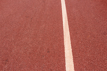 a white line marking on an asphalt road painted by red paint