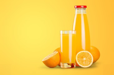 Orange juice and slices of orange on background