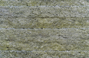 Thermal insulation material, rock wool. Thermal roof insulation layer. Mineral wool or mineral fiber, mineral cotton, mineral fibre, glass wool, MMMF, MMVF. Fiber thermal insulation close-up.