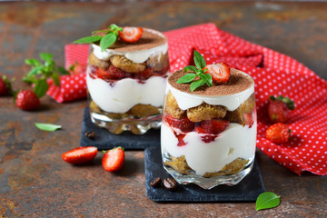 Italian dessert tiramisu with strawberries on an old grunge background