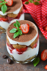 Italian dessert tiramisu with strawberries on an old grunge background