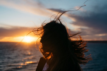 Long hair flying at sunset