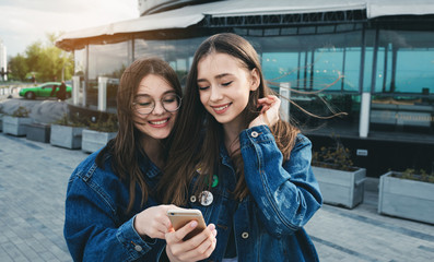 Young friends having fun with smartphone in spring day