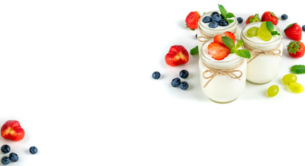 Fresh yogurt with berries in glass jars. Dairy products. Healthy food, dieting and breakfast concept. Long format for banner, copy space