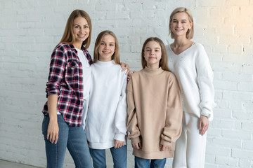 Portrait of beautiful lesbian family in casual clothes, two mom's and daughters