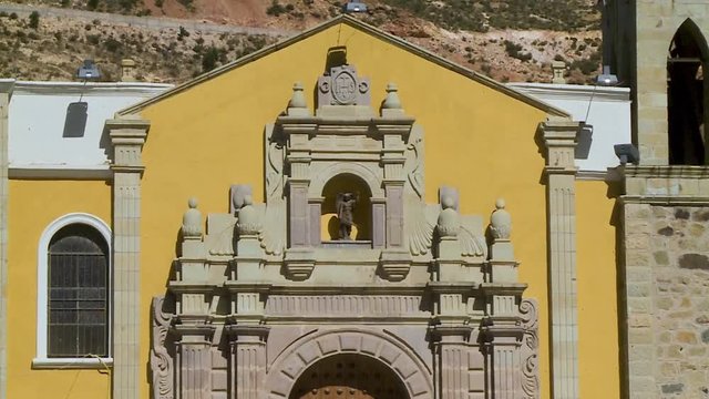 close-up low-angle tilting shot of the front of the historic and decorated church, Iglesia del socav'on , Oruro, Bolivia
