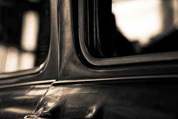 Detail of retro car window and body part, selective focus