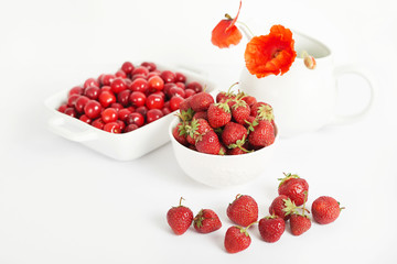 vegetarian and vegan food: strawberries and cherries on a white background, ecological clean products