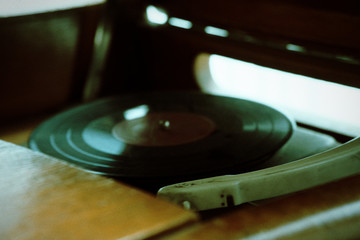 Turntable, Old record player stylus on a rotating disc, vintage filtered, selective focus