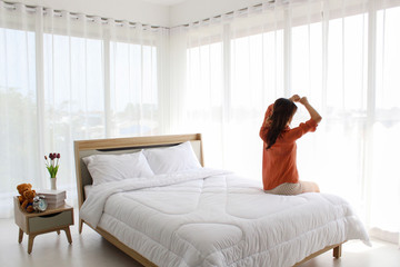 Background textures of Beautiful of Woman wake up on morning and sitting in the bedroom. 
