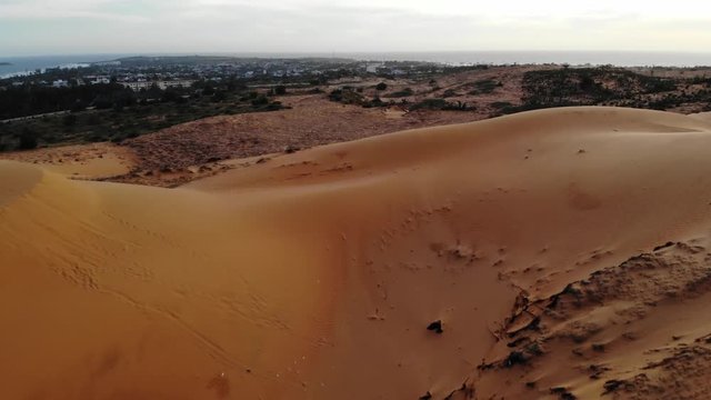 Impressive red sand dunes Mui Ne, Vietnam, aerial drone shot.