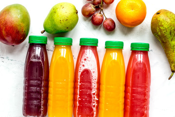 bottles of smoothie with fruits on white table top view