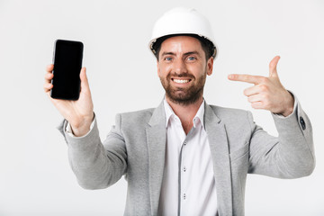 Confident bearded man builder wearing suit