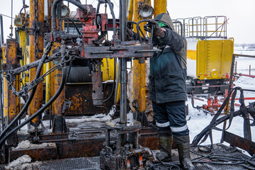 Workover rig working on a previously drilled well trying to restore production through repair....