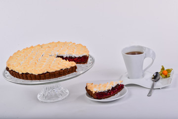 cherry pie on a dish with a cup of tea