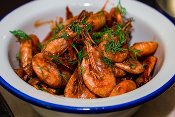 Prepared shrimps with dill in bowl on table close
