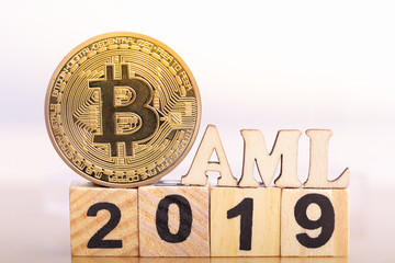 Bitcoin and Wood block word AML on Wood block word 2019.  Money laundering bitcoin concept. Anti Money Laundering. Blockchain technology.