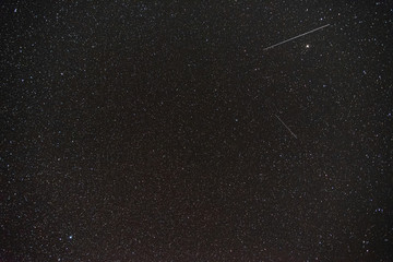 dark night sky with many stars and meteors background image