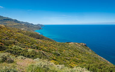 Fototapeta na wymiar Spectacular landscapes, awe-inspiring cliffs, charming villages and historical landmarks along the coastal road between Alghero and Bossa (SP 105), Sardinia, Italy. 