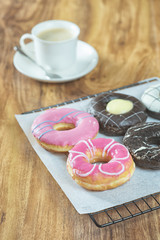 Obraz na płótnie Canvas Donuts and coffee on wooden table.