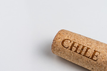 Wine cork isolated on the white. Record of the name of the Country Chile.