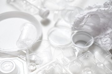 Waste management and disposal. Ecology problem. Empty plastic tableware on white background.