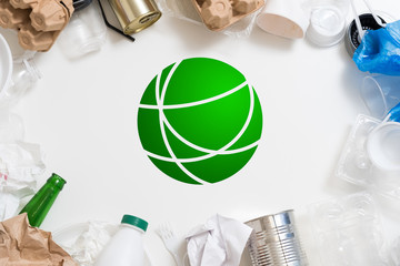 Waste management and sorting. Environmental protection. Plastic, paper, glass, metal garbage arranged around green symbol.