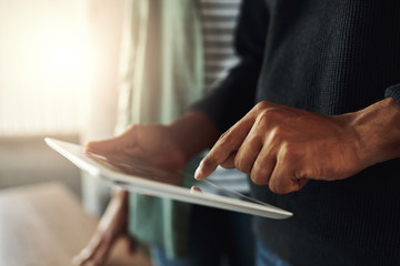 Close-up of a man touching on digital tablet