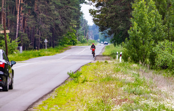 Father carries daughter by bike on highway