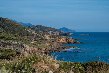 Fototapeta na wymiar Spectacular landscapes, awe-inspiring cliffs, charming villages and historical landmarks along the coastal road between Alghero and Bossa, Sardinia, Italy. One of the most panoramic spots in Italy.