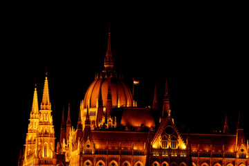 Obraz premium Budapest Hungary, 05.29.2019 Hungarian Parliament Building. night Budapest, glowing in gold. facade and roof of an old building