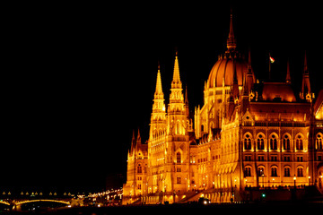 Obraz premium Budapest Hungary, 05.29.2019 Hungarian Parliament Building. night Budapest, glowing in gold. facade and roof of an old building