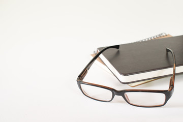 Books and glasses, white background