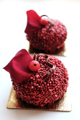 Obraz na płótnie Canvas Red textured desserts with red currant berries and edible red rose petal