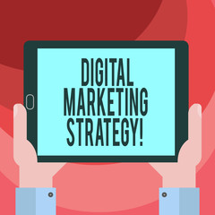 Text sign showing Digital Marketing Strategy. Conceptual photo actions that help achieve your company goals Hu analysis Hand Holding Blank Screen Tablet Smartphone Display Unit photo