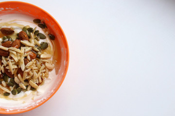 Healthy lifestyle breakfast in orange bowl, half