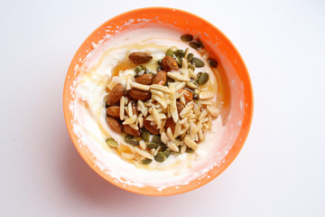 Healthy lifestyle breakfast in orange bowl top view