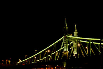 Fototapeta na wymiar Budapest Hungary, 05.29.2019 glowing liberty bridge across the Danube River. night Budapest glowing in gold