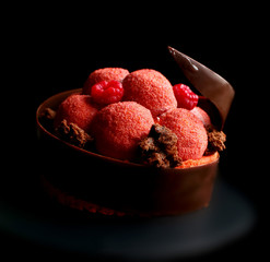 Textured red raspberry dessert with fresh berries, microwave sponge and chocolate spiral border