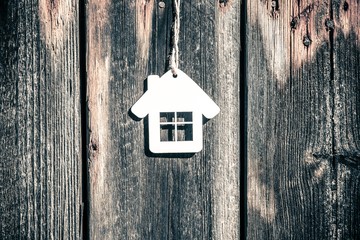 House symbol on a brown wooden background 
