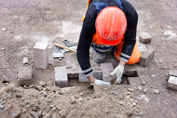 Worker To Repair Lays Paving Slabs. Brickwork Close-Up.