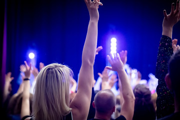 People raise their hands up.
