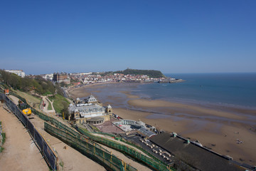 Fototapeta na wymiar View from clifftops across the bay at Scarborough, Yorkshire, UK on a clear blue sky sunny day