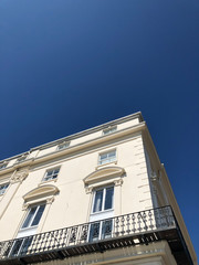 Fototapeta na wymiar facade of a white stucco fronted building with sky