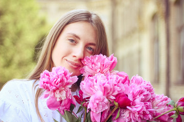 beautiful girl, no makeup, natural beauty, feminism. woman in a white dress, crosswise with a bouquet of peonies