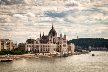 Obraz premium Building of the hungarian parliament in a Budapest, capital of Hungary, by the Danube river. One of the landmark of Budapest, and popular tourist destination.