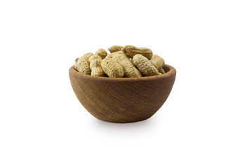 Peanut in shell on a white background. Top view. Peanut in wooden bowl isolated on white background. Peanut with copy space for text.