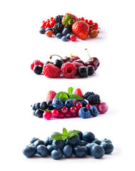 Set of fresh fruits and berries isolated a white background. Ripe currants, raspberries, cherries, strawberries, gooseberries, mulberries and bilberries. Mix berries on white background. 