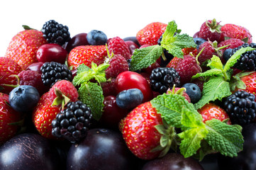 Ripe strawberries, blackberries, blueberries, raspberries, red berries abd plum. Mix berries and fruits. Top view. Background berries and fruits. Black-blue and red berries and fruits.